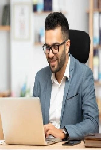 Tax professional working on a laptop in an office
